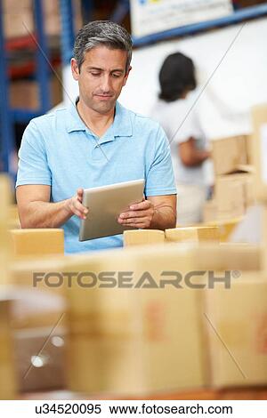 Workers In Warehouse Preparing Goods For Dispatch View Large Photo Image Stock Photography - Workers In Warehouse Preparing Goods For Dispatch. Fotosearch