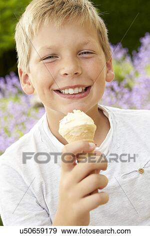 Stock Photo - Young Boy Eating Ice Cream Outdoors. Fotosearch