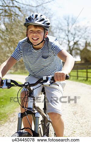 Young Boy Riding Bike Along Country Track View Large Photo Image Stock Photo - Young Boy Riding Bike Along Country Track. Fotosearch