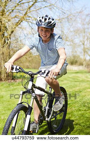 Young Boy Riding Bike Along Country Track View Large Photo Image Stock Photo - Young Boy Riding Bike Along Country Track. Fotosearch