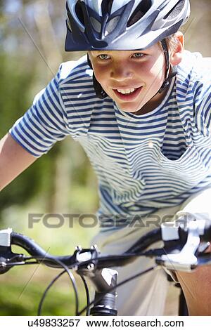 Stock Photo - Young Boy Riding Bike Along Country Track. Fotosearch