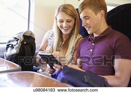 Young Couple Reading E Book On Train Journey View Large Photo Image Stock Image - Young Couple Reading E Book On Train Journey. Fotosearch