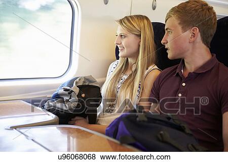 Stock Photo - Young Couple Relaxing On Train Journey. Fotosearch