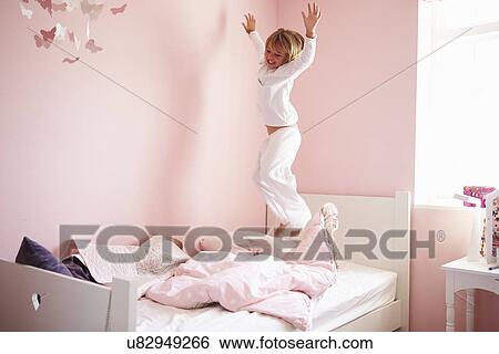 Young Girl Jumping On Her Bed View Large Photo Image Stock Photograph - Young Girl Jumping On Her Bed. Fotosearch