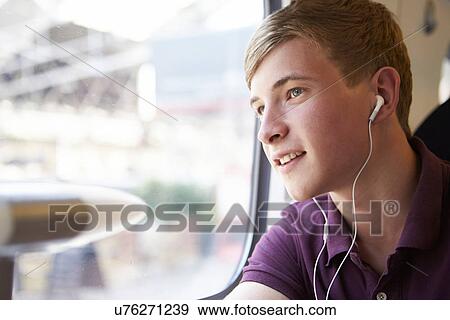 Young Man Listening To Music On Train Journey View Large Photo Image Stock Photo - Young Man Listening To Music On Train Journey. Fotosearch