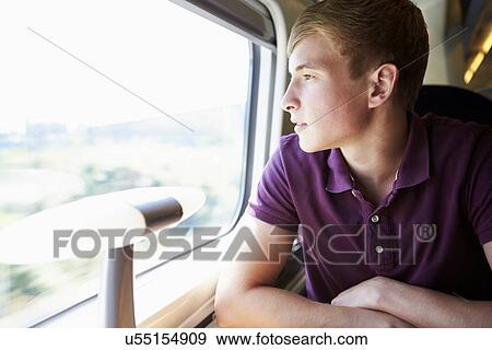 Young Man Relaxing On Train Journey View Large Photo Image Stock Photo - Young Man Relaxing On Train Journey. Fotosearch