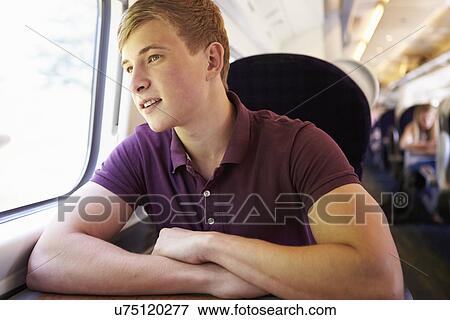 Young Man Relaxing On Train Journey View Large Photo Image Stock Photo - Young Man Relaxing On Train Journey. Fotosearch