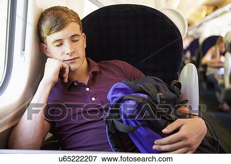 Young Man Resting On Train Journey View Large Photo Image Stock Photo - Young Man Resting On Train Journey. Fotosearch