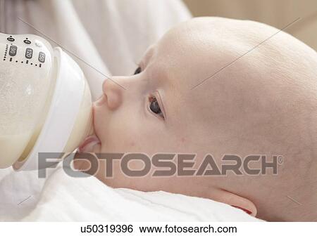 Baby being bottle fed View Large Photo Image Stock Photograph - Baby being bottle fed. Fotosearch