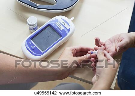 Stock Image - Blood glucose test. Fotosearch