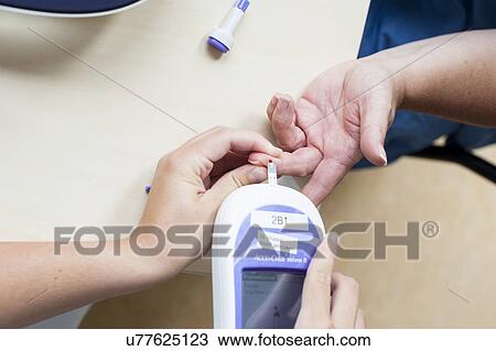 Stock Image - Blood glucose test. Fotosearch
