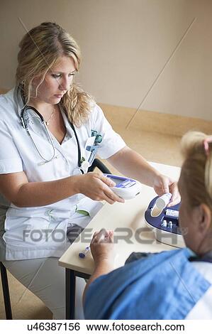 Stock Photograph - Blood glucose test. Fotosearch