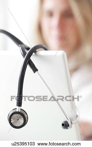 Doctor using a laptop View Large Photo Image Stock Image - Doctor using a laptop. Fotosearch