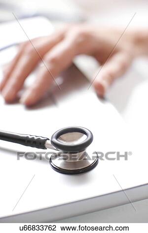 Stock Image - Doctor using a laptop. Fotosearch