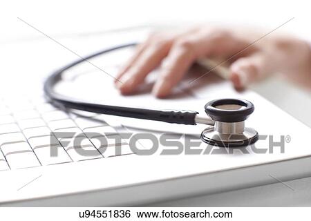 Doctor using a laptop View Large Photo Image Stock Photograph - Doctor using a laptop. Fotosearch