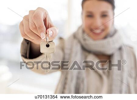 Picture - Happy woman with a key. Fotosearch