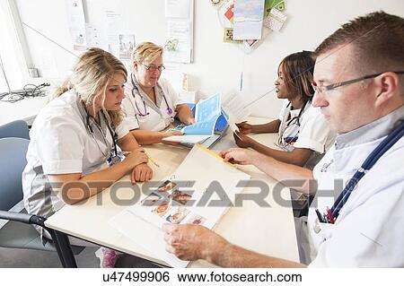 Stock Photograph - Hospital nursing meeting. Fotosearch