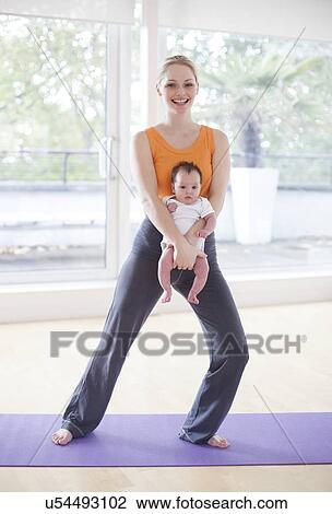 Mother and baby doing yoga View Large Photo Image Stock Image - Mother and baby doing yoga. Fotosearch