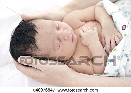 Stock Photo - Mother and baby girl. Fotosearch