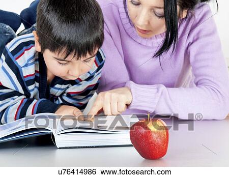 Stock Photograph - Mother and son reading. Fotosearch