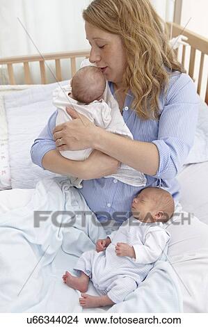 Mother and two week old twins View Large Photo Image Picture - Mother and two week old twins. Fotosearch