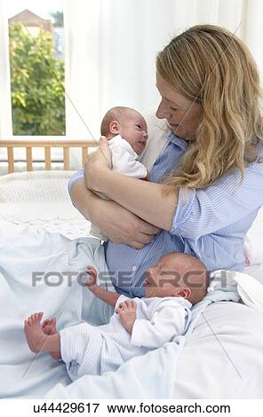 Mother and two week old twins View Large Photo Image Stock Photo - Mother and two week old twins. Fotosearch