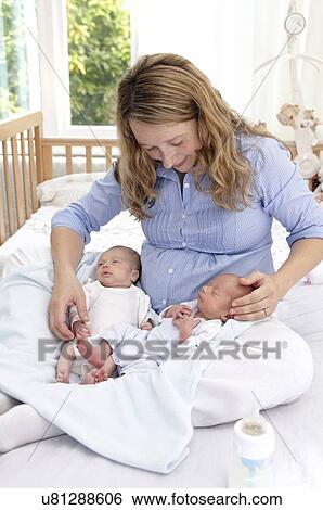 Mother and two week old twins View Large Photo Image Stock Photograph - Mother and two week old twins. Fotosearch
