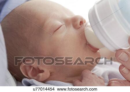 Mother feeding two week old son View Large Photo Image Picture - Mother feeding two week old son. Fotosearch