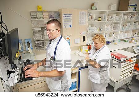 Nurse accessing drug records View Large Photo Image Picture - Nurse accessing drug records. Fotosearch