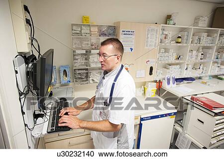 Stock Image - Nurse accessing drug records. Fotosearch