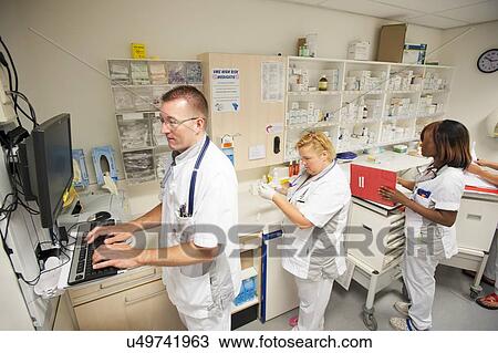 Stock Image - Nurse accessing drug records. Fotosearch