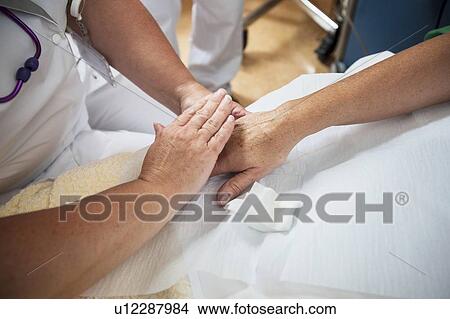Nurse preparing a patient for an IV line View Large Photo Image Picture - Nurse preparing a patient for an IV line. Fotosearch