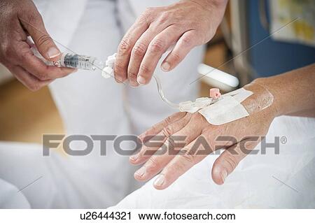 Nurse preparing a patient for an IV line View Large Photo Image Stock Image - Nurse preparing a patient for an IV line. Fotosearch