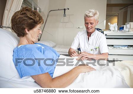 Nurse preparing a patient for an IV line View Large Photo Image Stock Image - Nurse preparing a patient for an IV line. Fotosearch