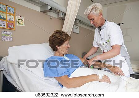 Nurse preparing a patient for an IV line View Large Photo Image Stock Image - Nurse preparing a patient for an IV line. Fotosearch