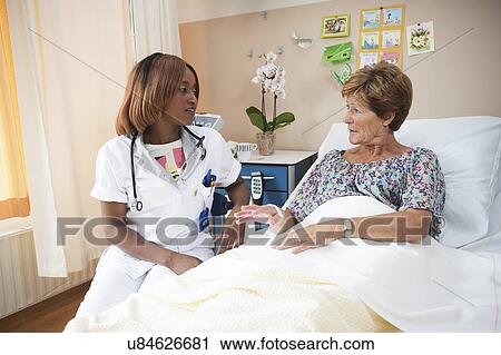 Nurse preparing a patient for an IV line View Large Photo Image Stock Image - Nurse preparing a patient for an IV line. Fotosearch