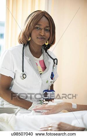 Nurse preparing a patient for an IV line View Large Photo Image Stock Image - Nurse preparing a patient for an IV line. Fotosearch
