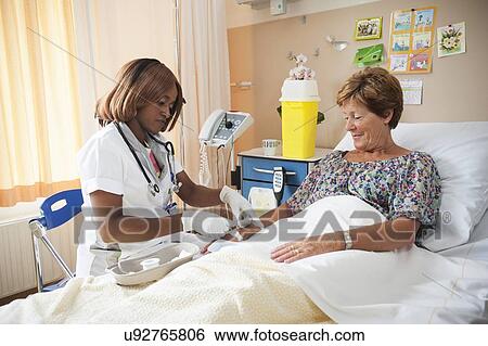Nurse preparing a patient for an IV line View Large Photo Image Stock Photograph - Nurse preparing a patient for an IV line. Fotosearch