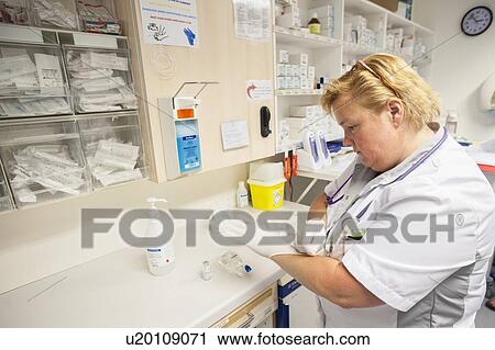 Stock Image - Nurse preparing drugs. Fotosearch