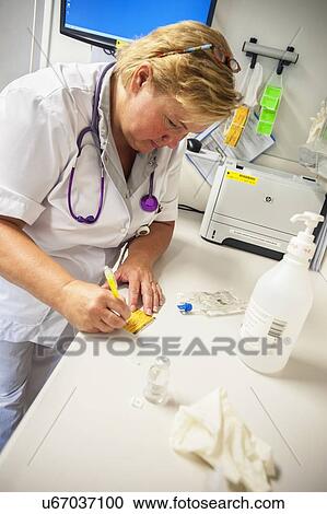 Stock Image - Nurse preparing drugs. Fotosearch