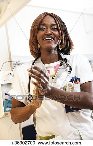 Stock Image - Nurse washing her hands. Fotosearch