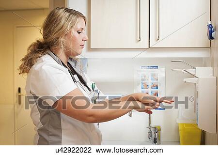 Stock Image - Nurse washing her hands. Fotosearch