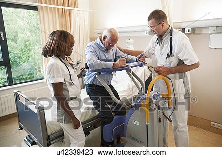 Nurses helping a patient out of bed View Large Photo Image Stock Image - Nurses helping a patient out of bed. Fotosearch