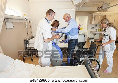 Nurses helping a patient out of bed View Large Photo Image Stock Photography - Nurses helping a patient out of bed. Fotosearch