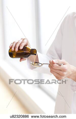 Stock Photograph - Pouring medicine. Fotosearch
