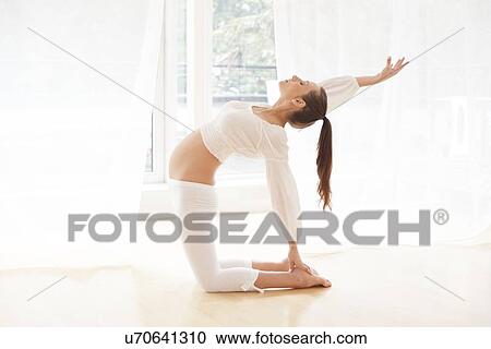 Pregnant woman practicing yoga View Large Photo Image Stock Image - Pregnant woman practicing yoga. Fotosearch