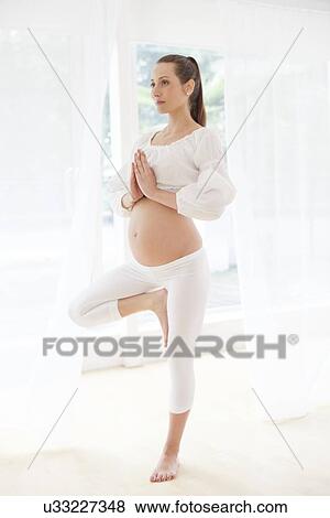 Stock Photo - Pregnant woman practicing yoga. Fotosearch