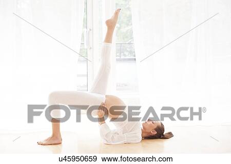 Stock Photo - Pregnant woman practicing yoga. Fotosearch