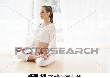 Pregnant woman practicing yoga View Large Photo Image Stock Photo - Pregnant woman practicing yoga. Fotosearch