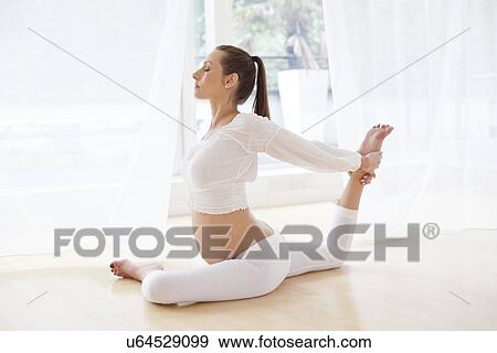 Pregnant woman practicing yoga View Large Photo Image Stock Photo - Pregnant woman practicing yoga. Fotosearch